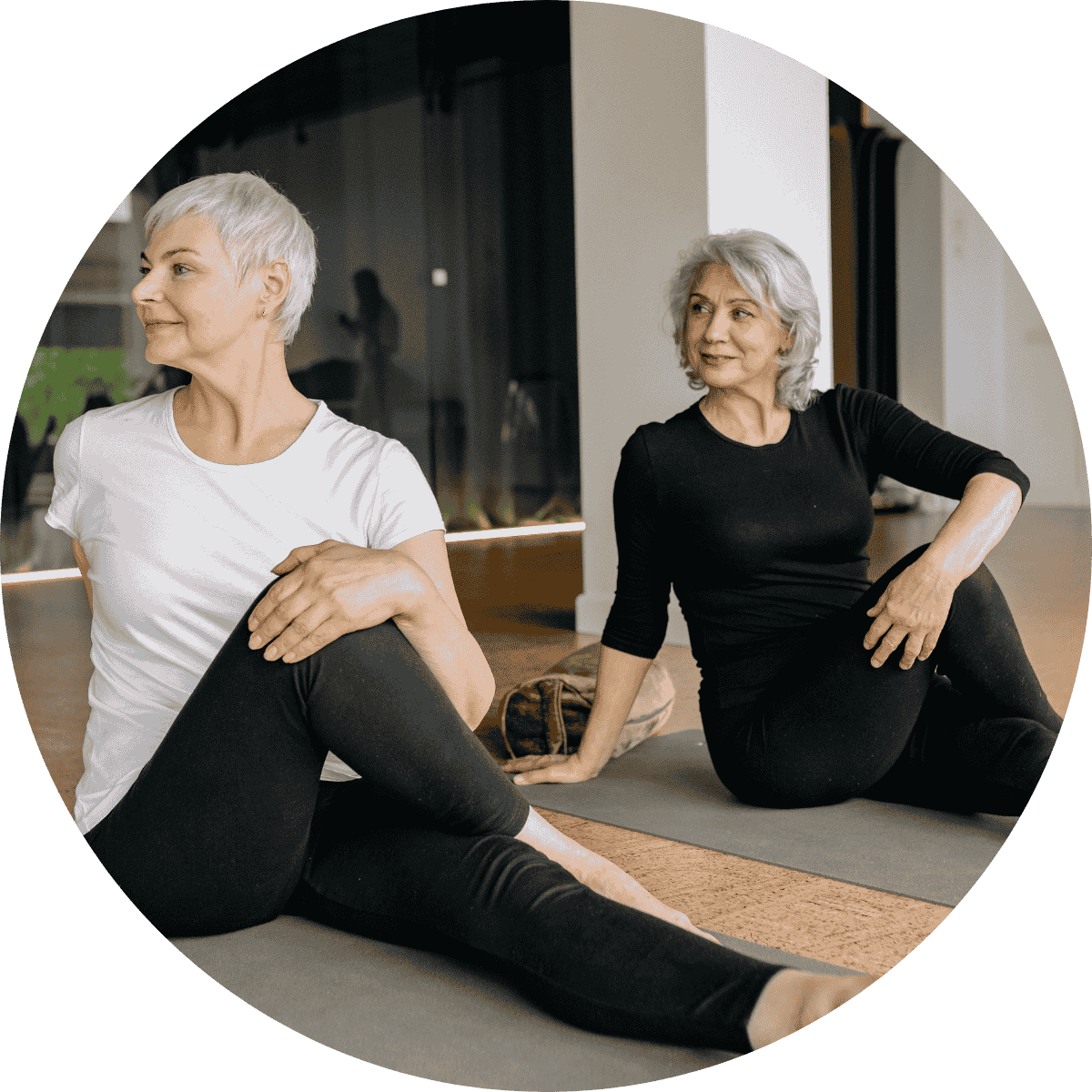 two older woman practicing trauma informed yoga