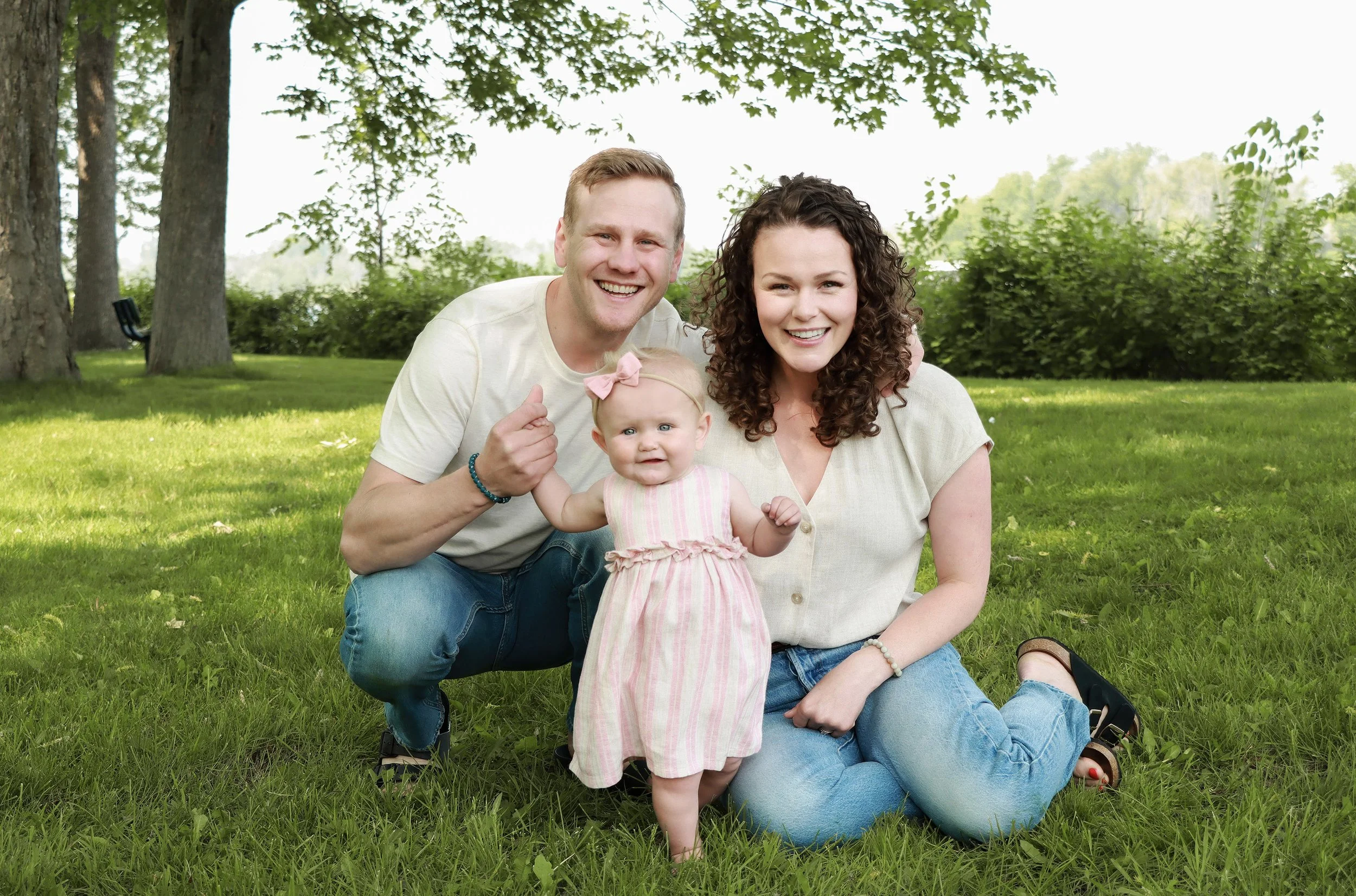 Carleton Place family smiling together for a photo taken by local photographer at Riverside Park in the spring.