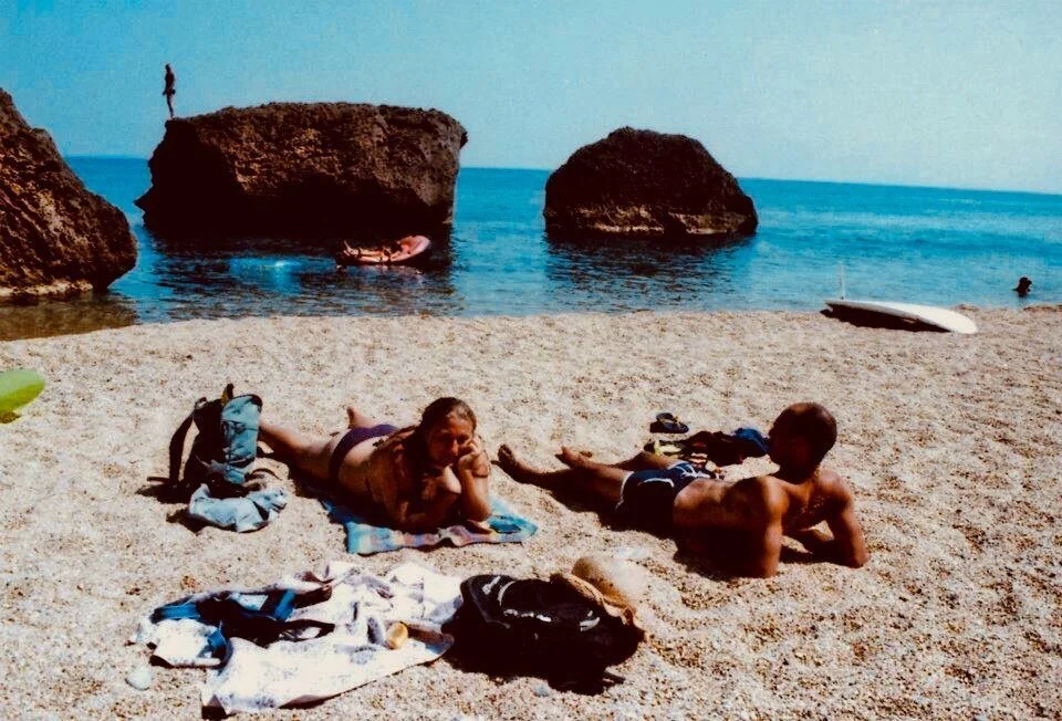 I remember the way the pebbles crunched beneath our feet as we walked slowly over mounds of rocky beach. 
.
I remember the stillness in the air, the bright hot sun beating down on the back of our necks as we searched the twists and turns of coves for