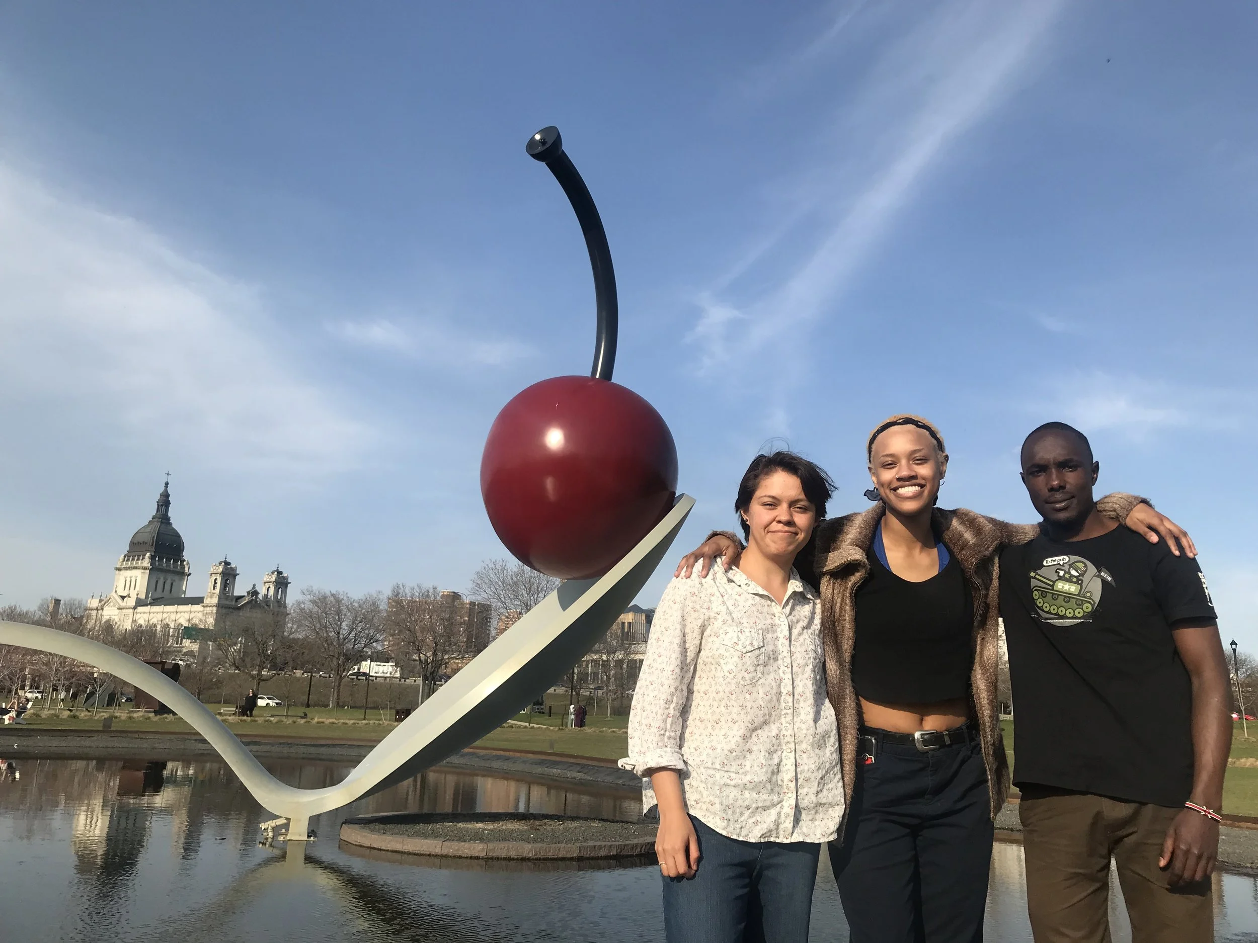 A cherry, a spoon, some salad and sweet carrots