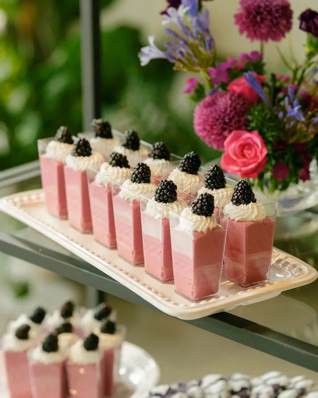   Portland Oregon wedding dessert shooters featuring layered berry mousse topped with whipped cream and fresh blackberries.  