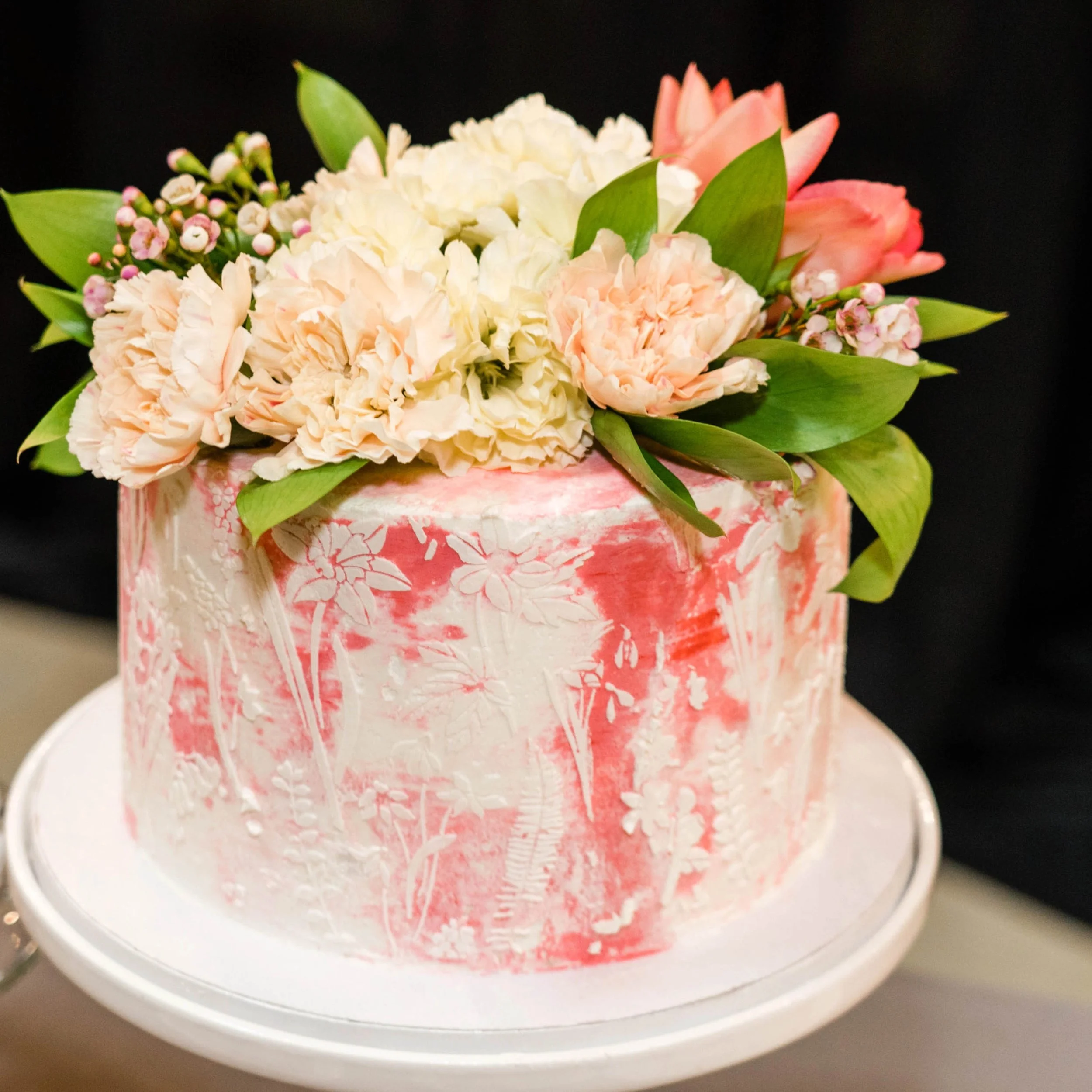   Portland Oregon wedding cake with floral buttercream design and fresh flowers, displayed as a custom dessert centerpiece for a reception.  