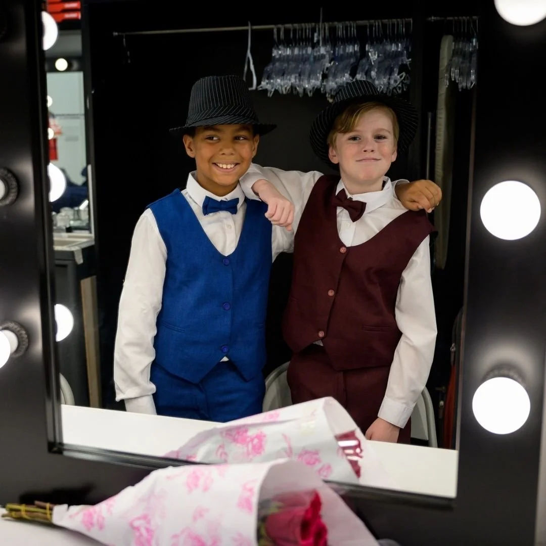 two boys preparing for performance