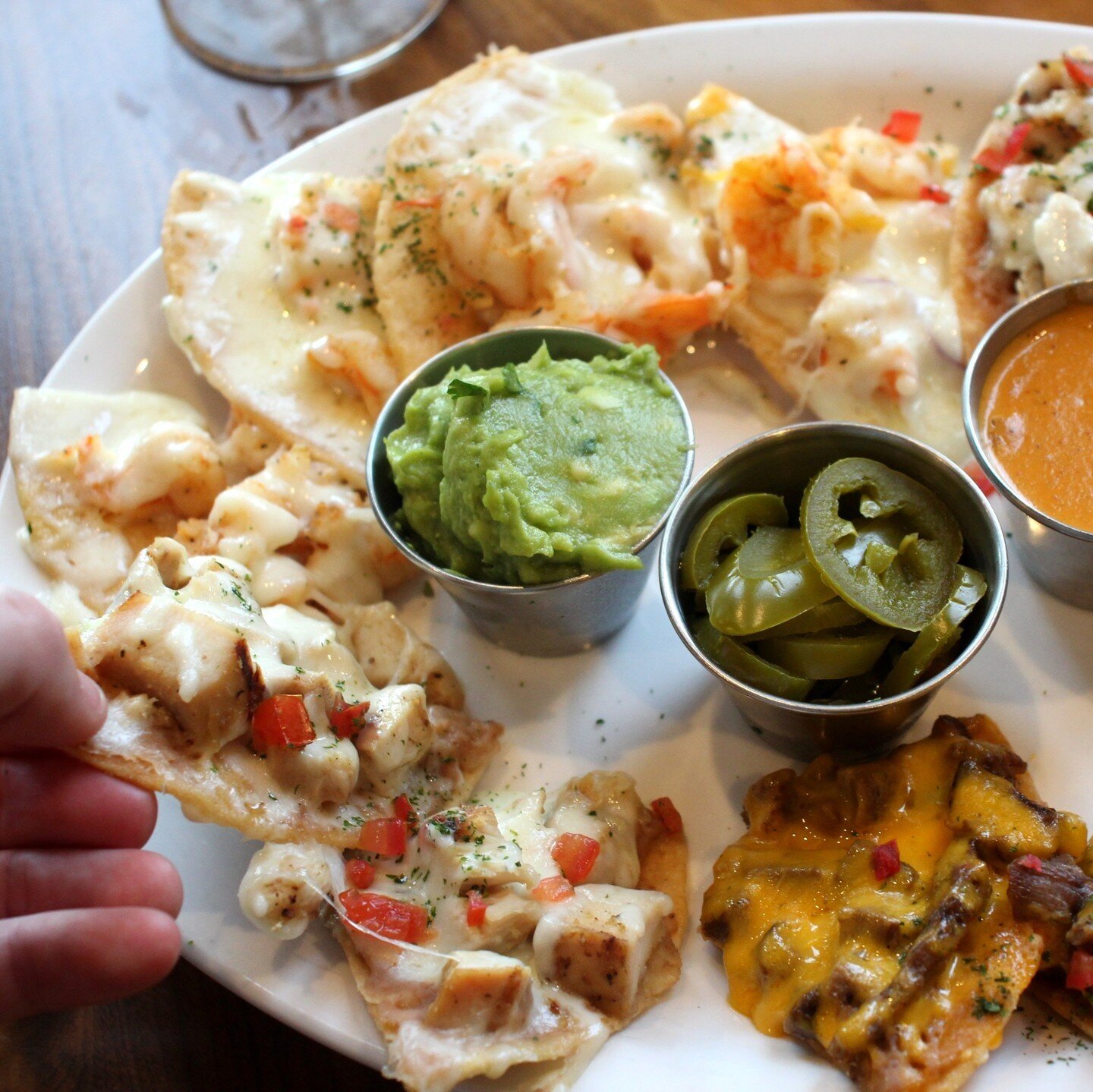 Looking for a flavor-filled fiesta in every bite? Look no further than our signature Fiesta Nachos! Loaded with juicy shrimp, tender chicken, and flavorful beef, our nachos are a party on your plate. 😋🎉