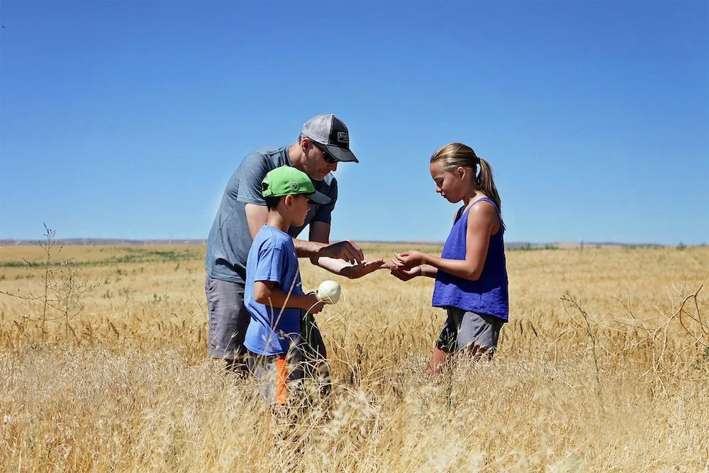 Scott France learning about wheat with his children.