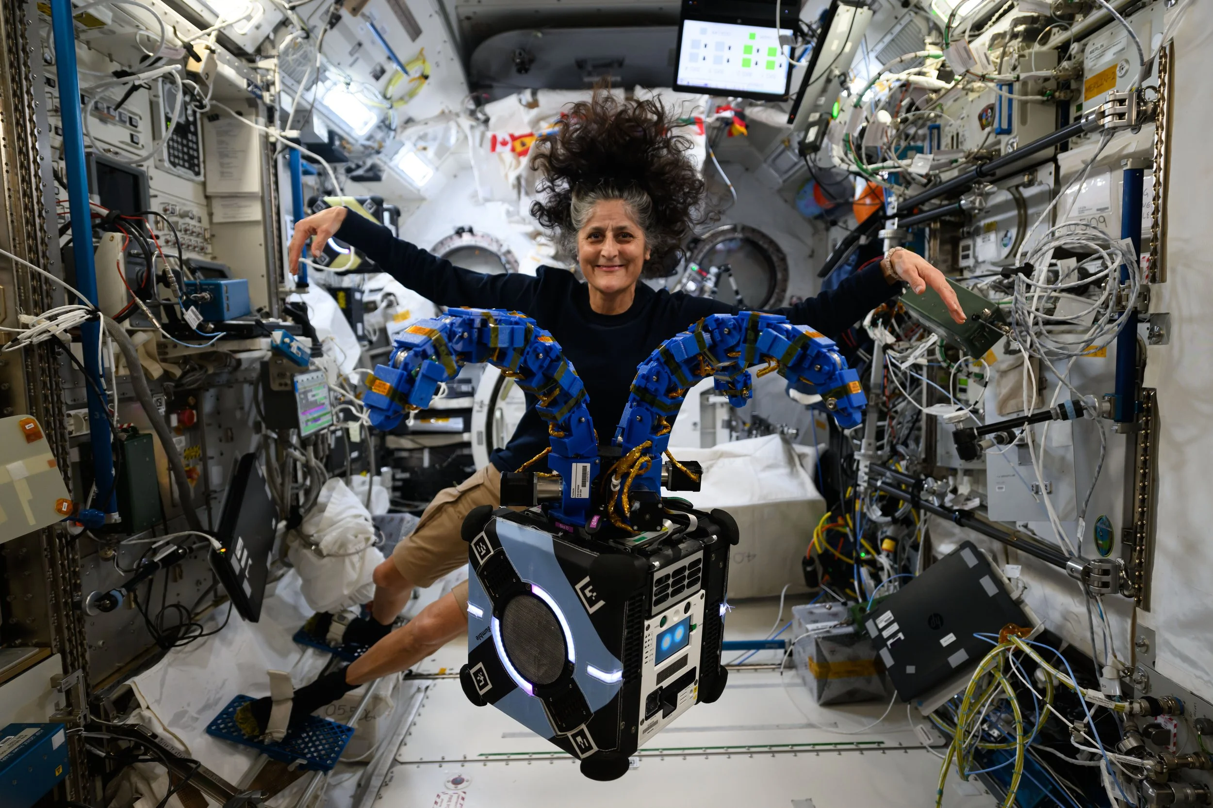 Astronaut Suni Williams checks out the Astrobee robotic free-flyer outfitted with REACCH