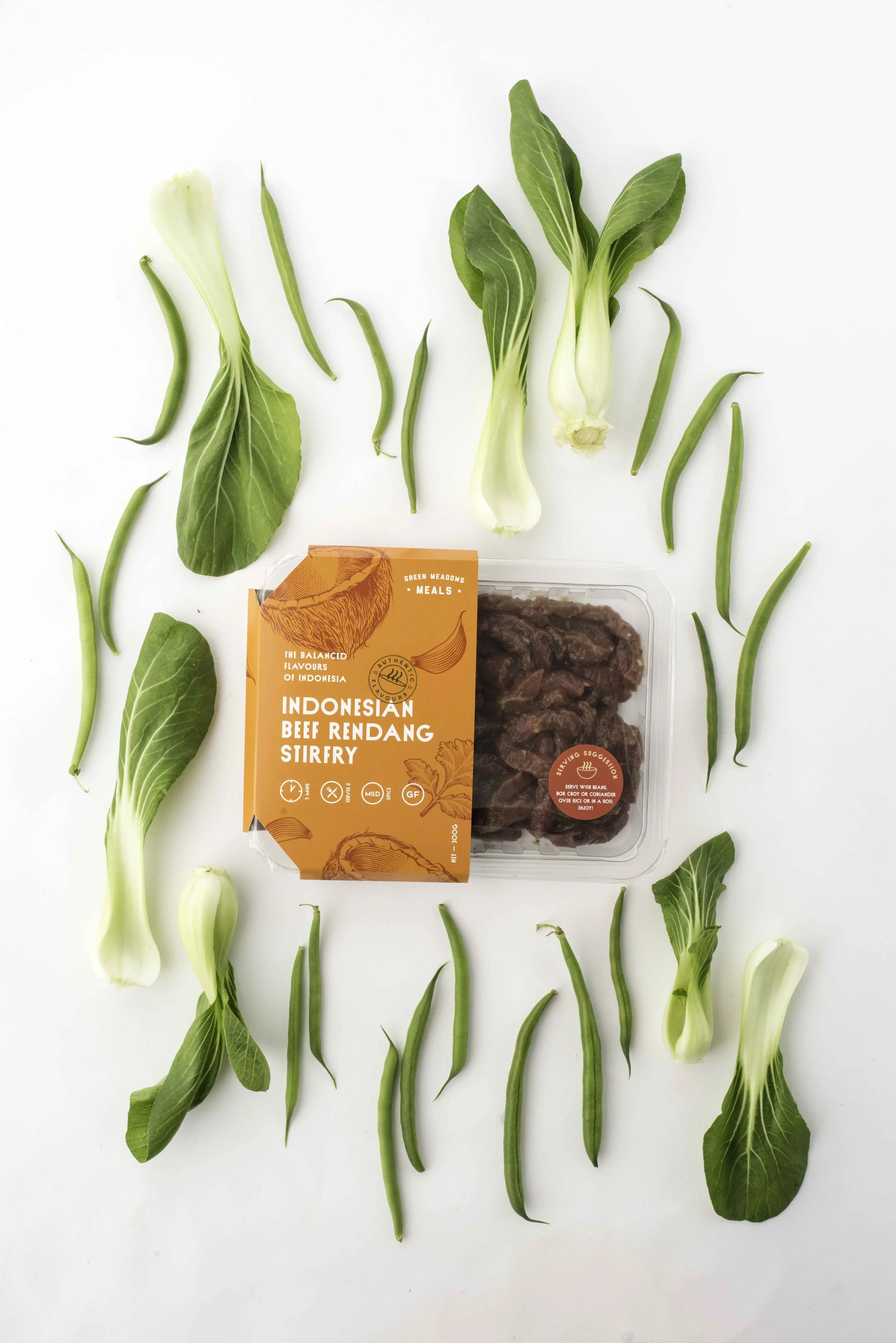 Green Meadow’s Beef’s Indonesian Stirfry Beef. Shot flaylay on a white background with bok choy and green beans.