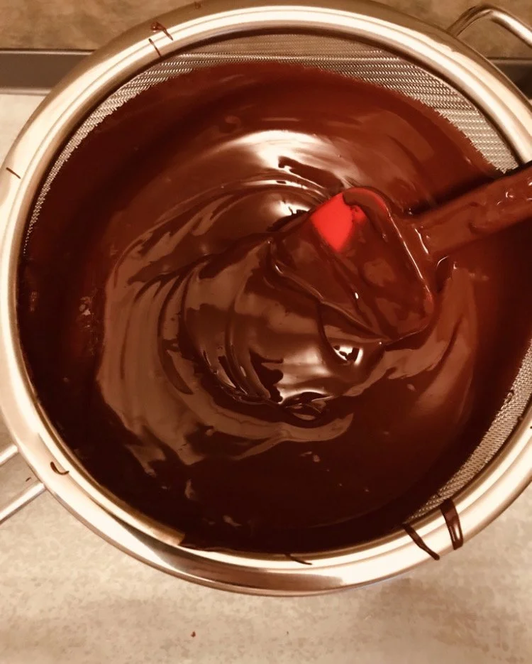 Straining some fresh microbatch chocolate made with PNG cacao. 