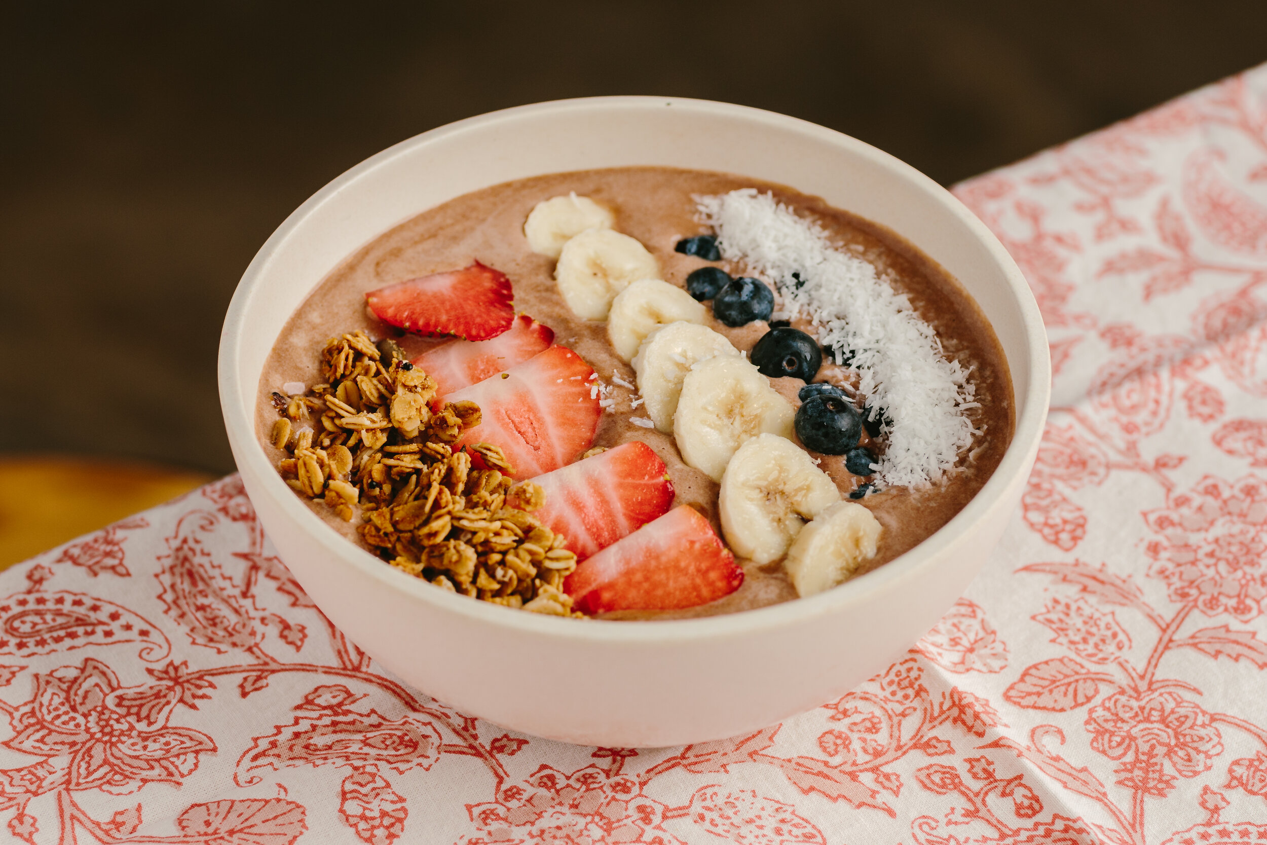 3. Chocolate Protein Smoothie BowlChocolate smoothie with locally sourced granola, banana, strawberries, coconut flakes, and a chocolate protein powder.