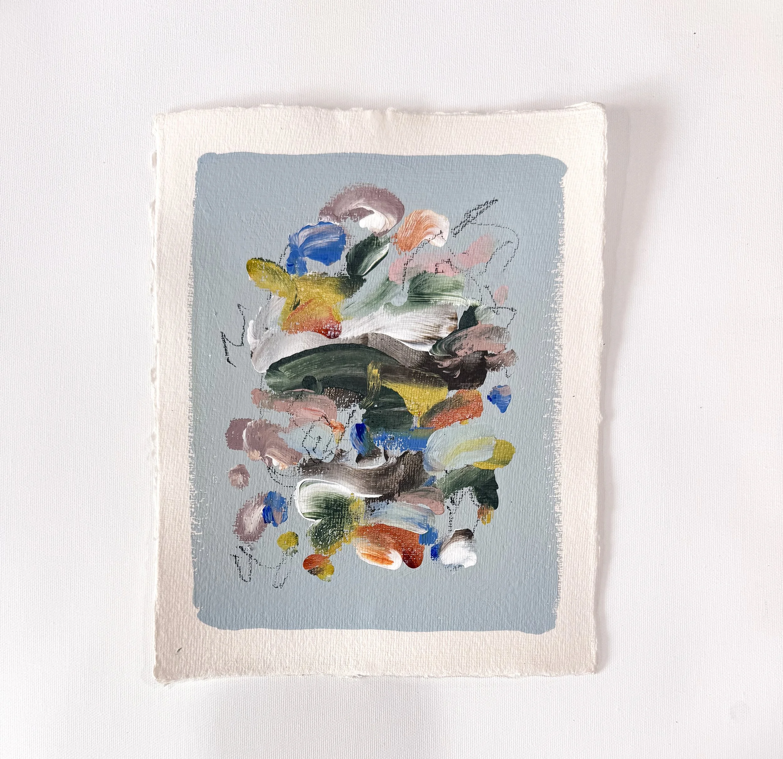 Small original abstract painting on handmade paper with light blue background and multicolor marks