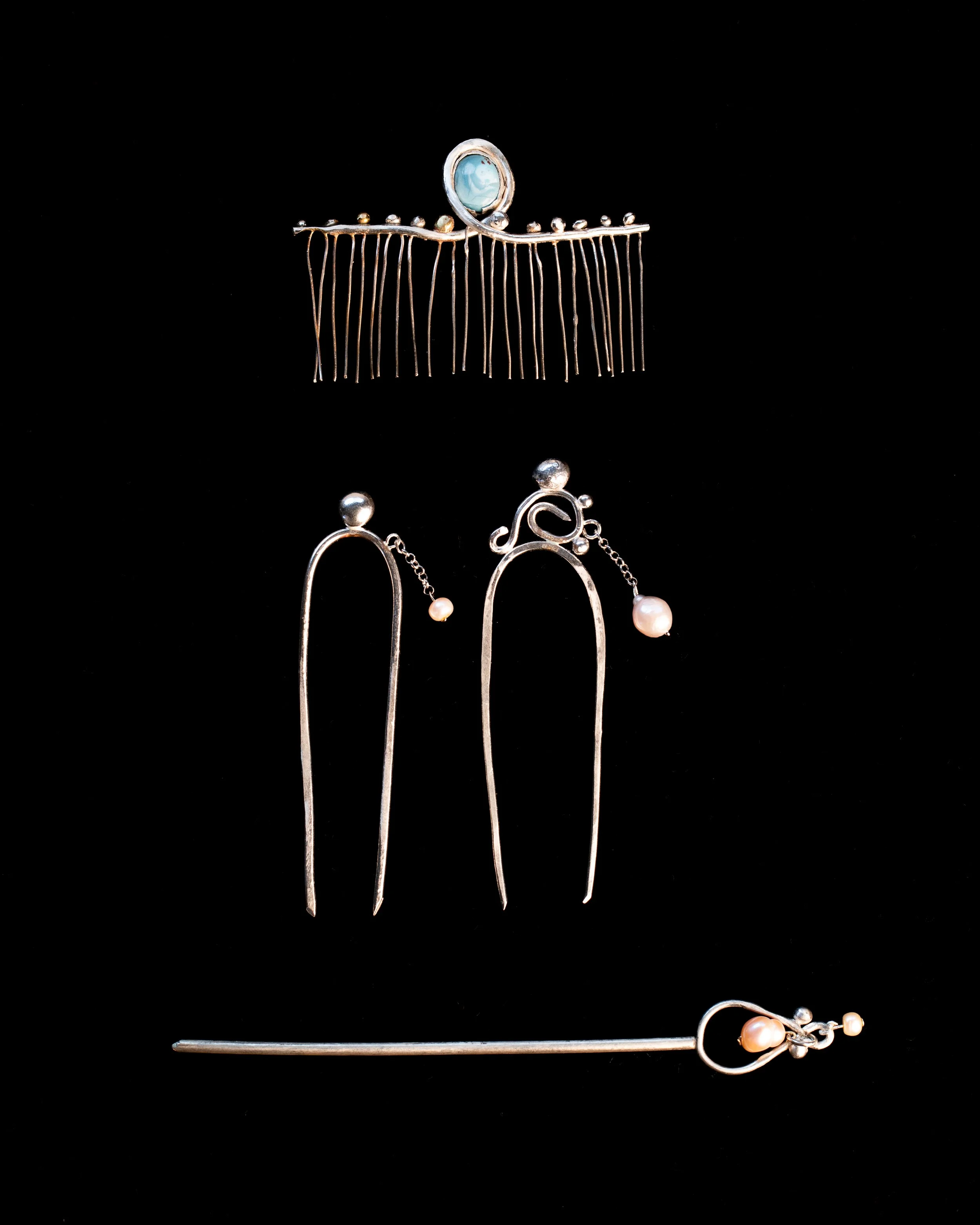 A collection of Ulsi Omen combs and Hair pins all one of a kind made in silver and pearls