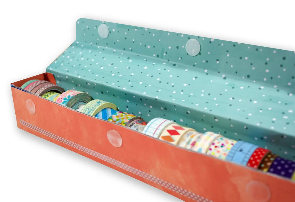 If you desire, decorate the outside of the box. Add stickers, embellishments, lettering, and other decoration to give it your style. Here’s how mine turned out using paper die cuts, lettering, enamel hearts and Washi from the Finders Keepers collect…