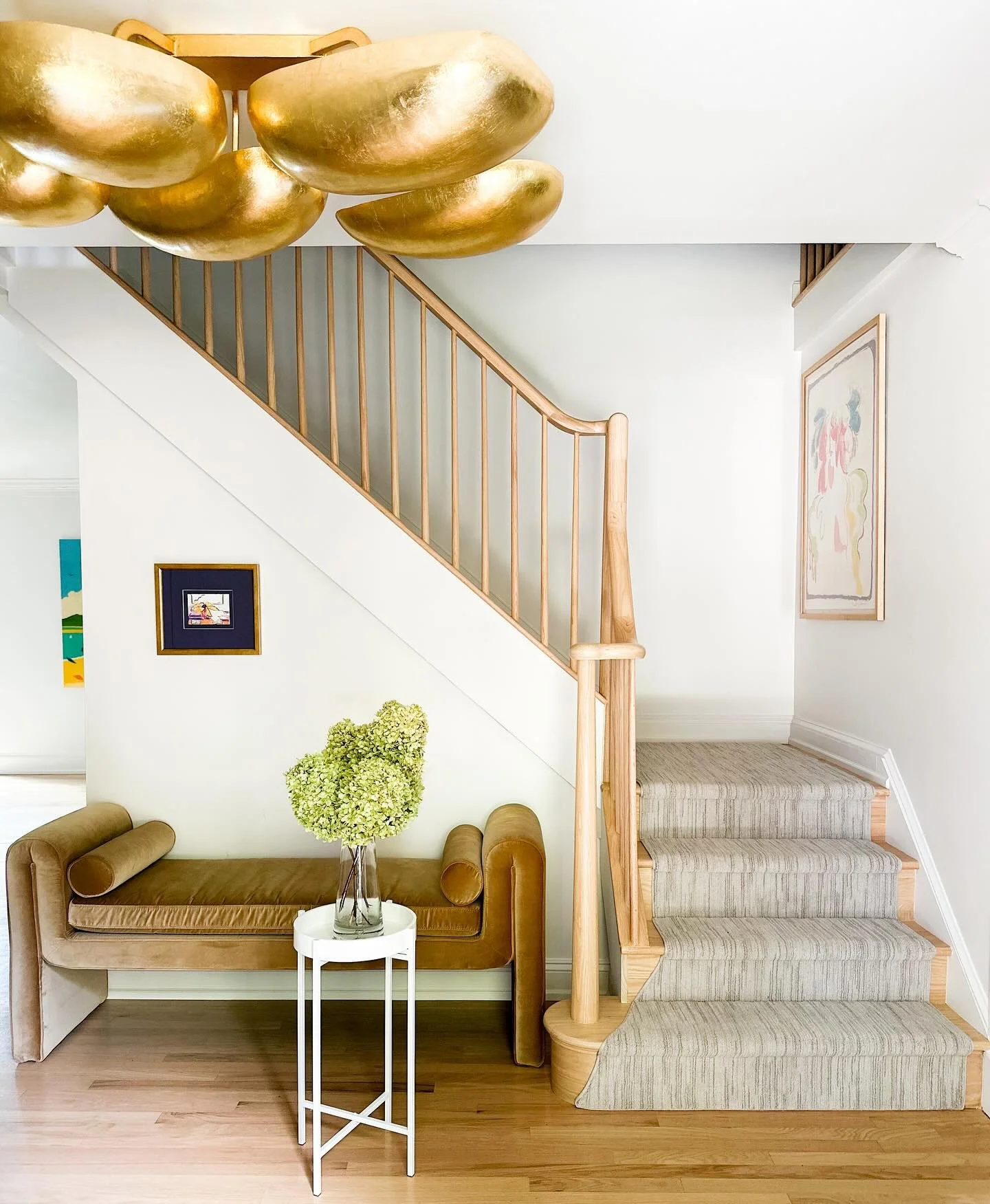 A WARM welcome starts here ::

This entryway transformation features a new staircase, statement lighting, and a chic bench styled with art and treasures from my client&rsquo;s fabulous collection, including the florals, designed by the incredibly tal