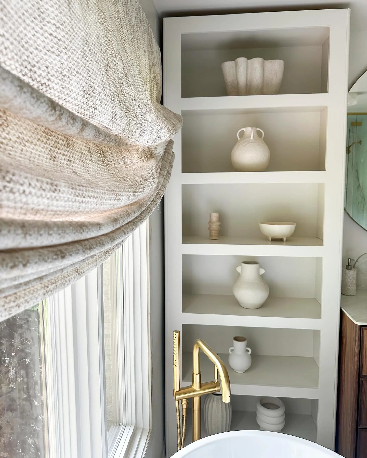 A little slice of zen: 
Custom bookshelf styled with organic, textured layers meets the soft elegance of a motorized relaxed roman shade. Every detail curated for that warm, spa-like calm&mdash;because luxury lives in the details. 

#darabeitlerinter