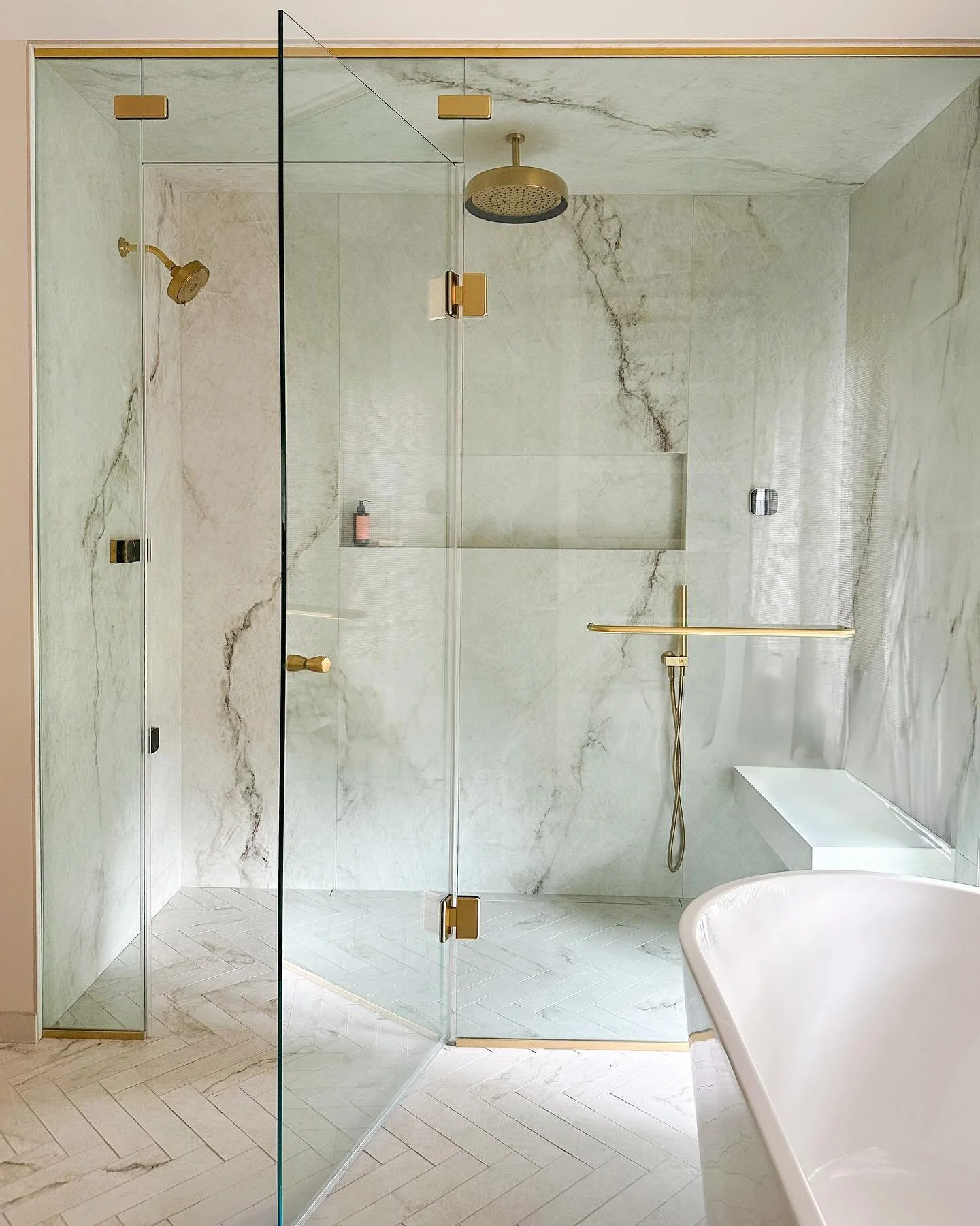 Luxury, reimagined. Indulge in the ultimate steam shower experience featuring an oversized niche, overhead rainfall, floating bench and a sleek linear drain. 

#darabeitlerinteriors 
#dmvinteriordesigner 
#potomachomes 
#bathroominspo 
#shower 
#luxu