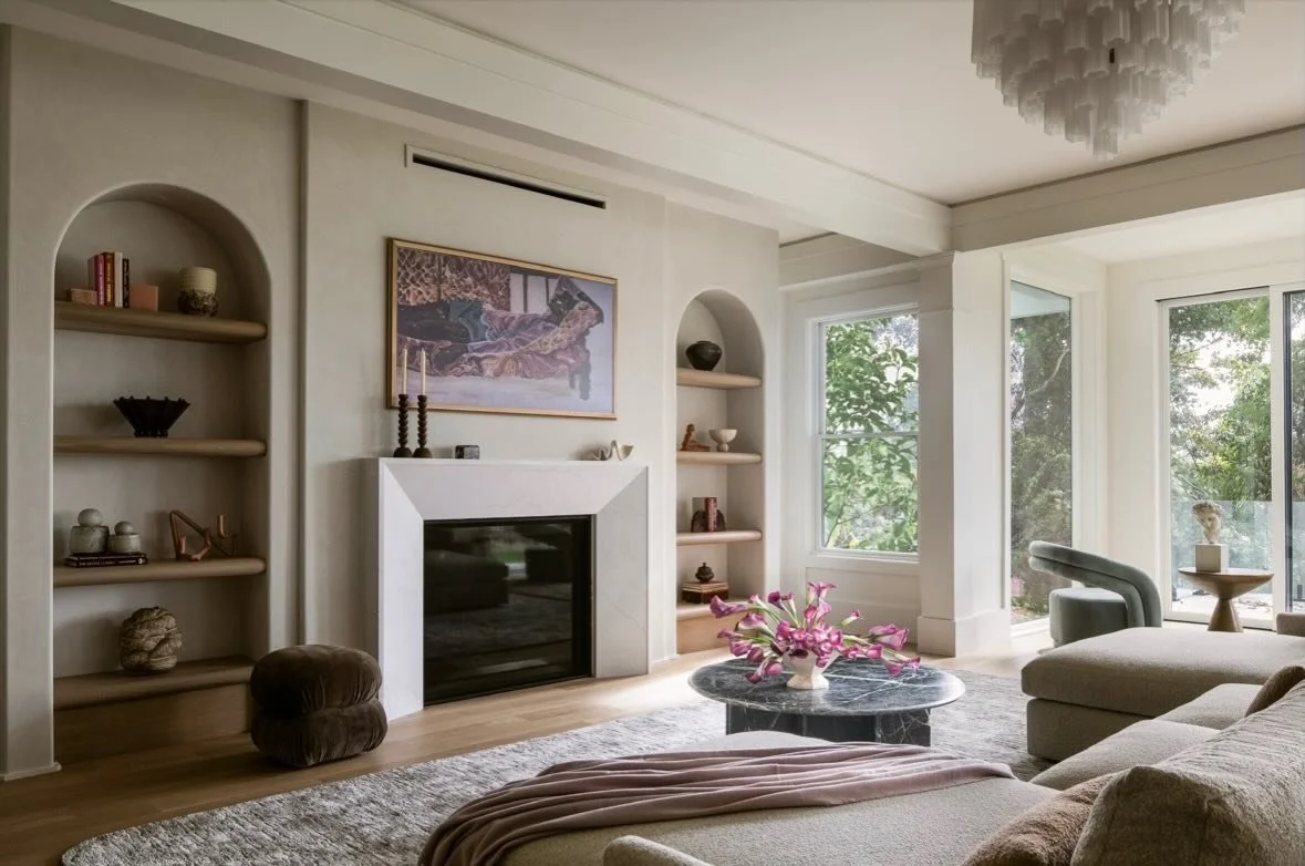 Soft curves, layered textures, and a palette pulled from nature create a living space that feels both grounded and elevated. From the sculptural fireplace surround to the arched built-ins and quiet tonal moments, every detail was designed to bring wa
