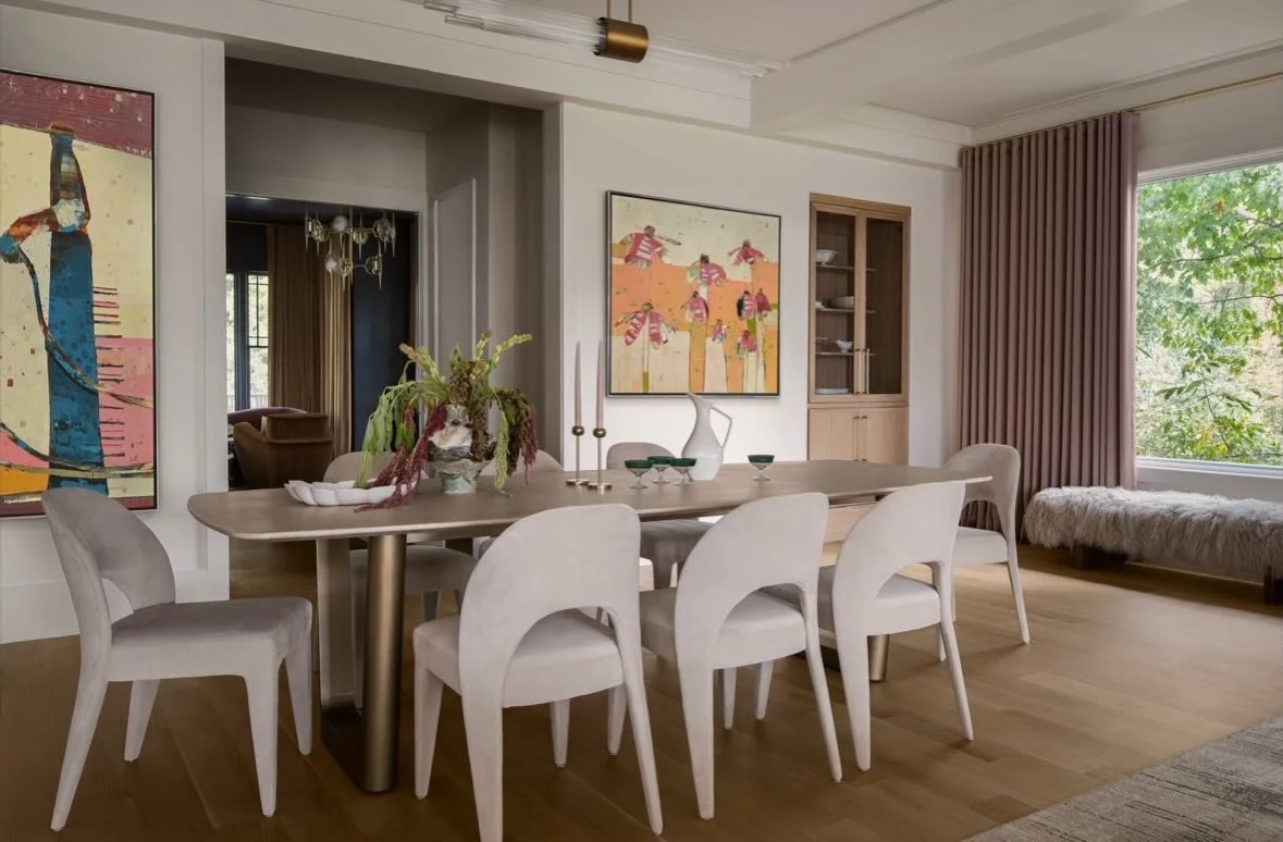 Designed for gathering, this dining space layers sculptural silhouettes, warm wood tones, and soft textiles to create an atmosphere that feels both elevated and inviting. Custom cabinetry adds a refined sense of function and display, while tailored d