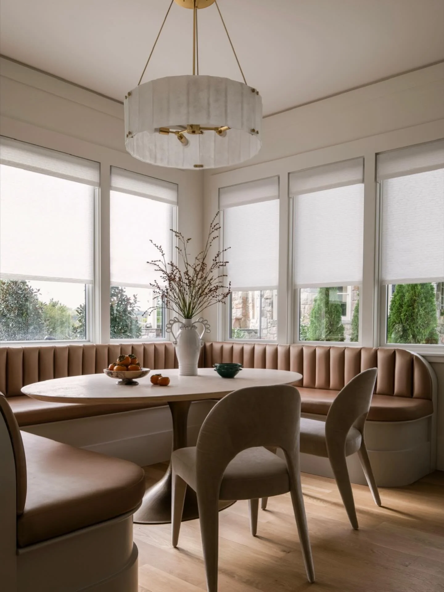 Where mornings linger a little longer.

This custom eat-in kitchen nook is wrapped in warm metallic channel-tufted banquette seating and layered with soft neutrals. This family-favorite space feels both refined and inviting &mdash; the perfect balanc