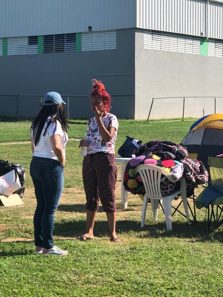 Angelique Sina speaking with one of the victims displaced after the earthquakes in Puerto Rico