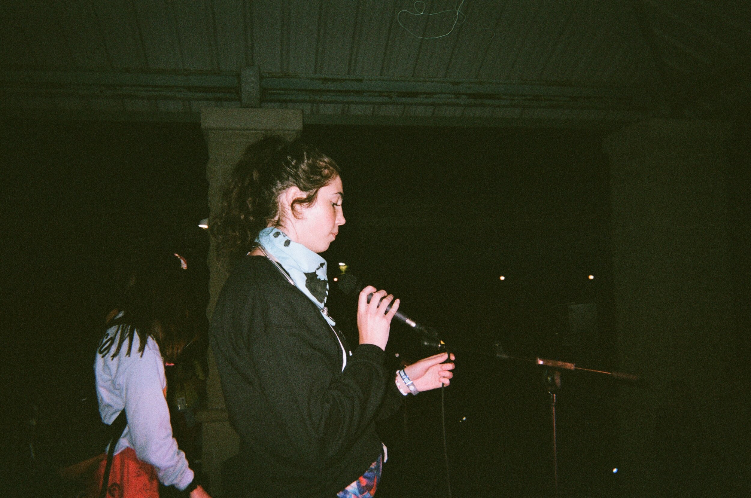 FAM Night at Western University during O-Week 2019. The Arts and Humanities Head Soph takes the mic and sings happy birthday to her boyfriend sitting in the crowd.