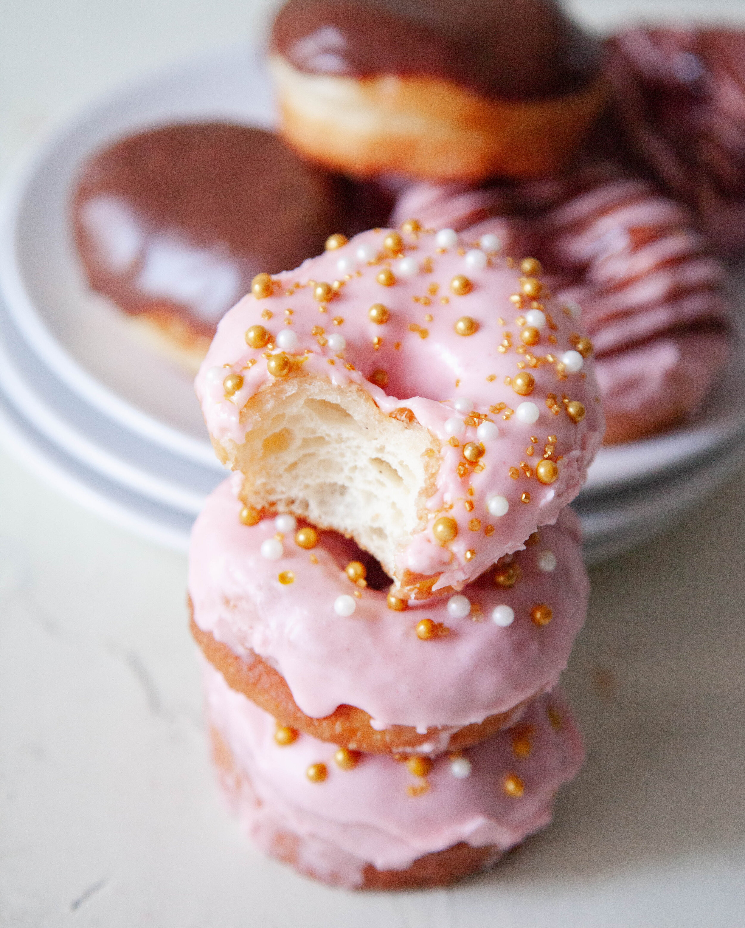 A Stack of Strawberry Doughnuts with Sprinkles