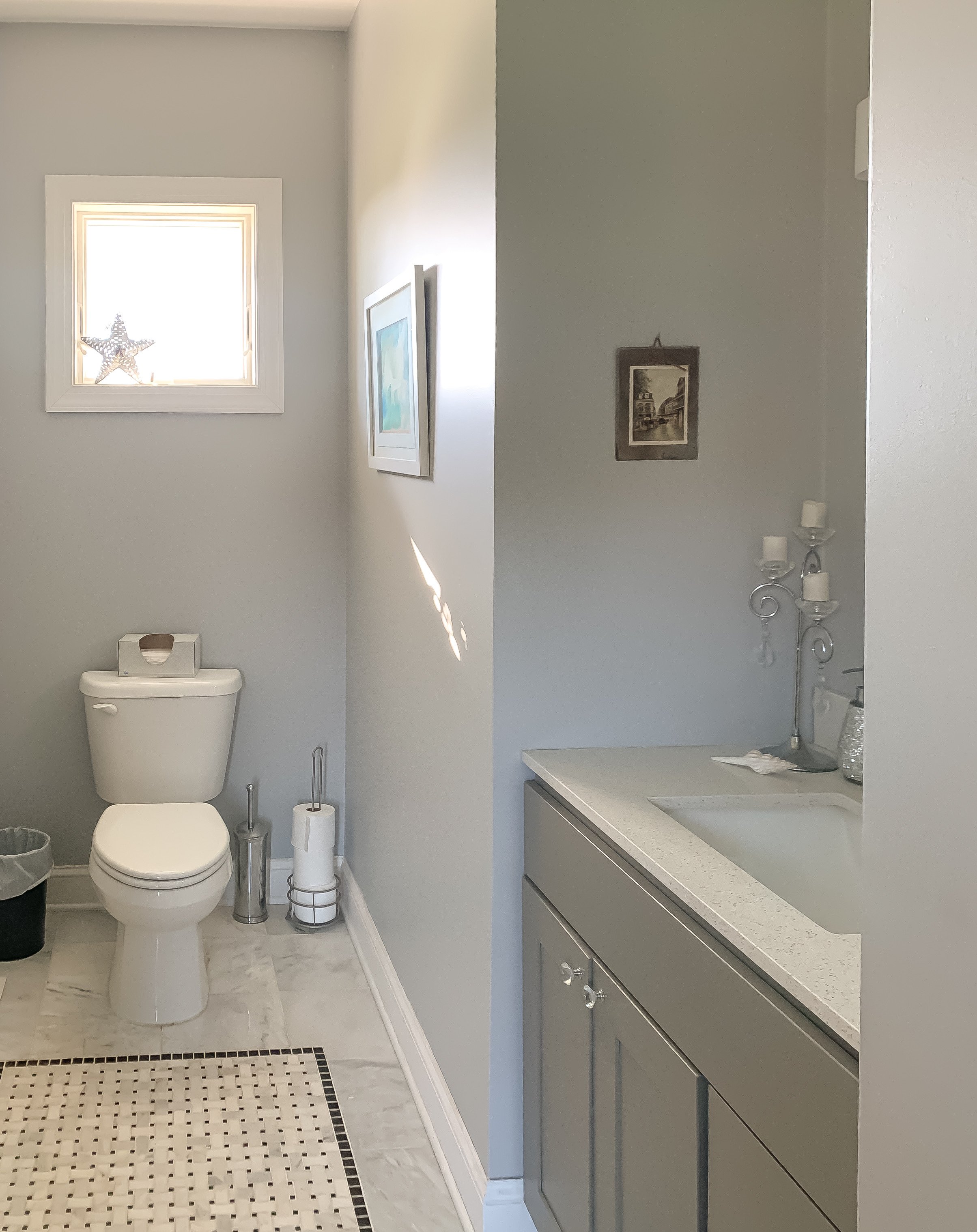Farmhouse powder room with grey cabinets and marble floors.JPEG