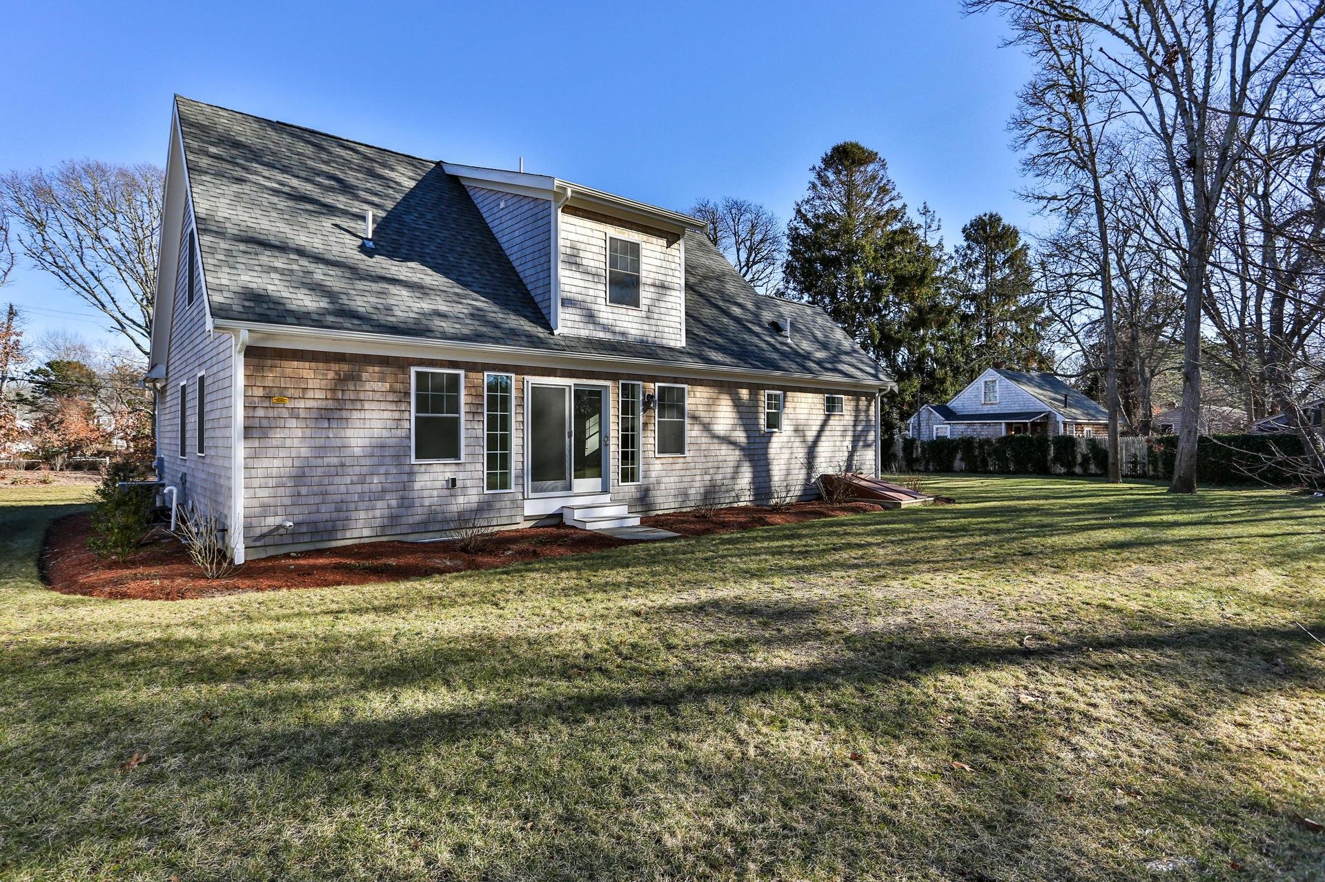 Exterior view of cedar shake home with white windows.jpeg