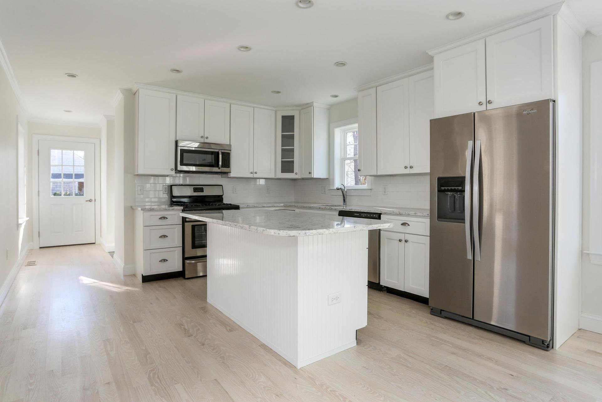 White Kitchen with Beadboard center island and granite countertops.jpeg