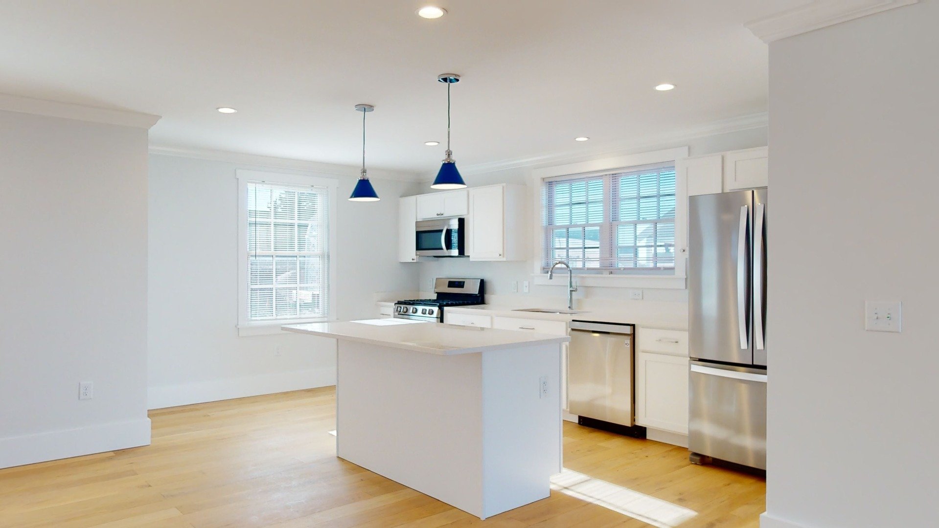 Clean white kitchen with shaker cabinets in modular home.jpeg