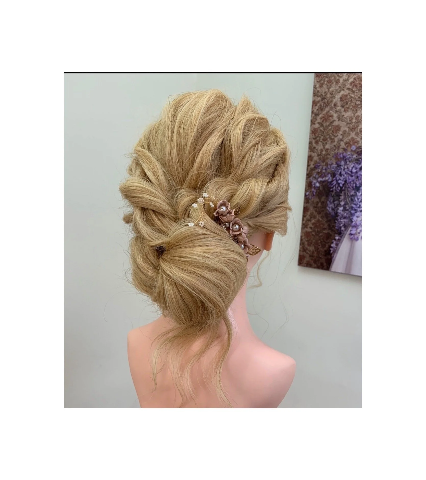 Textured blonde updo with soft structure, secure pinning and a decorative hairpiece designed for long-lasting hold.