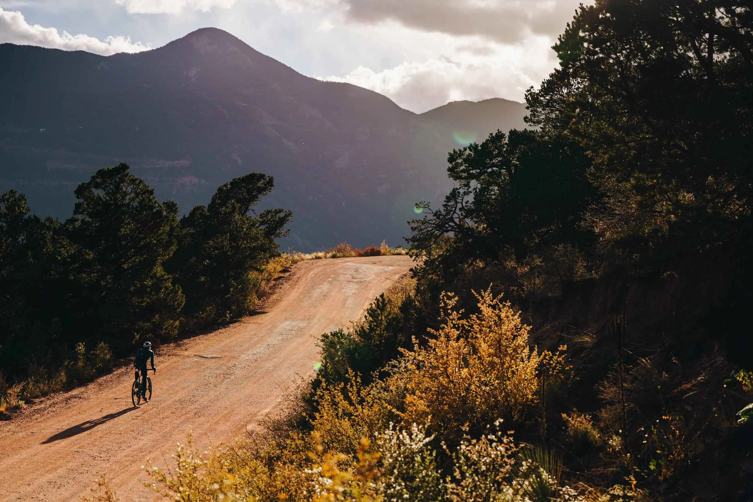 bike rider riding on a dirt road in the mountains