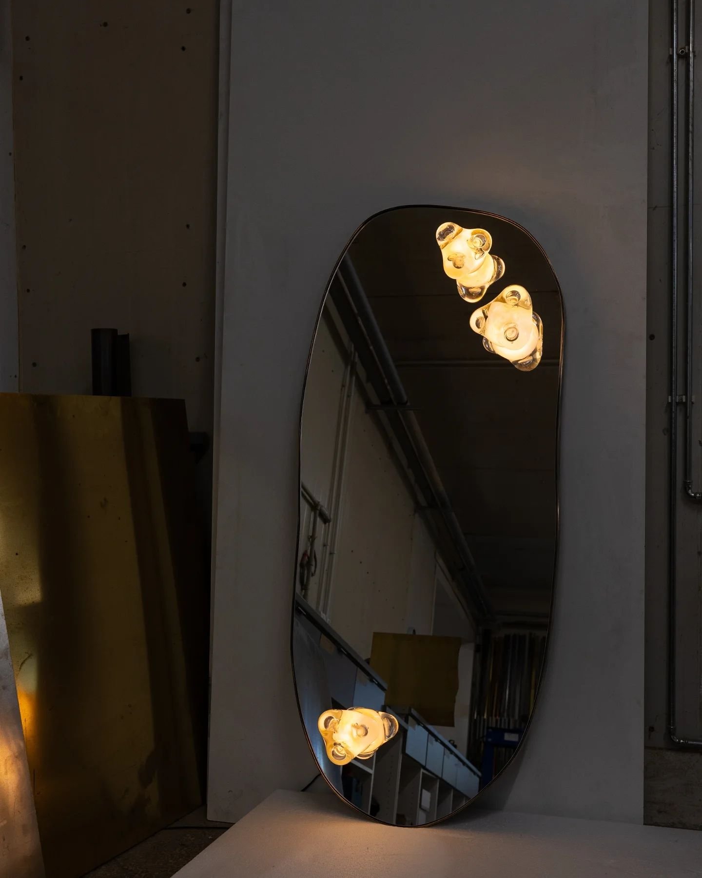 A recent commission for a very special client. Mirror with patinated brass and powder pink mouth-blown glass.

The glass lights come from my series of Glass Poems.

&quot;losing through you what seemed myself;i find
selves unimaginably mine;beyond
so