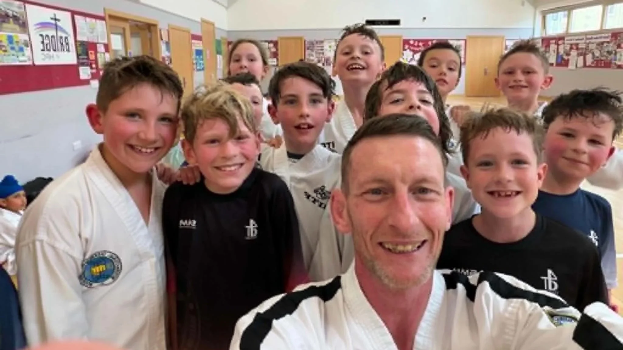 Sweaty, red-faced, smiling kids after a SMMA Junior Taekwondo class in Hlenebsurgh with Master Steven Mclaren