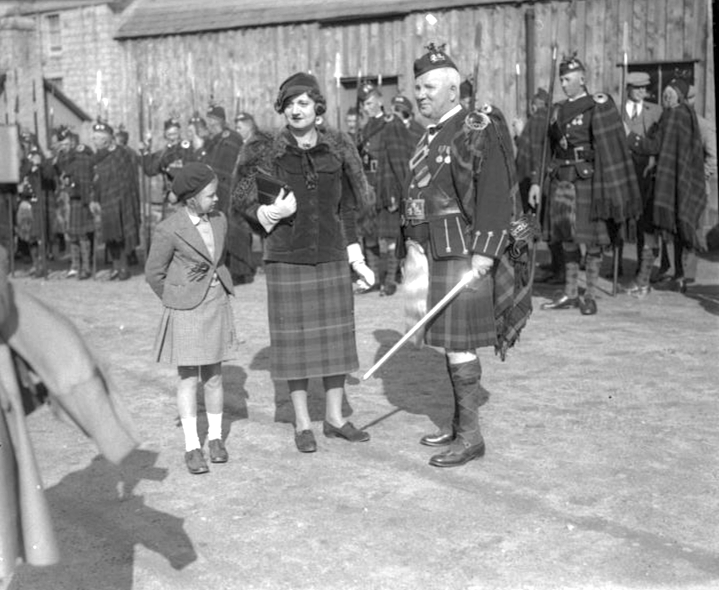 Mr J B Hosie, Factor at Mar, with Mrs Myrtle Farquharson or D'Erlanger of Invercauld. The Duff Highlanders behind. 1938 © St Andrews University