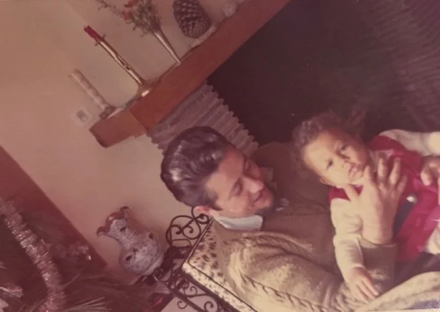 Maryline with her Papa in France in her grandma's house not willing to smile