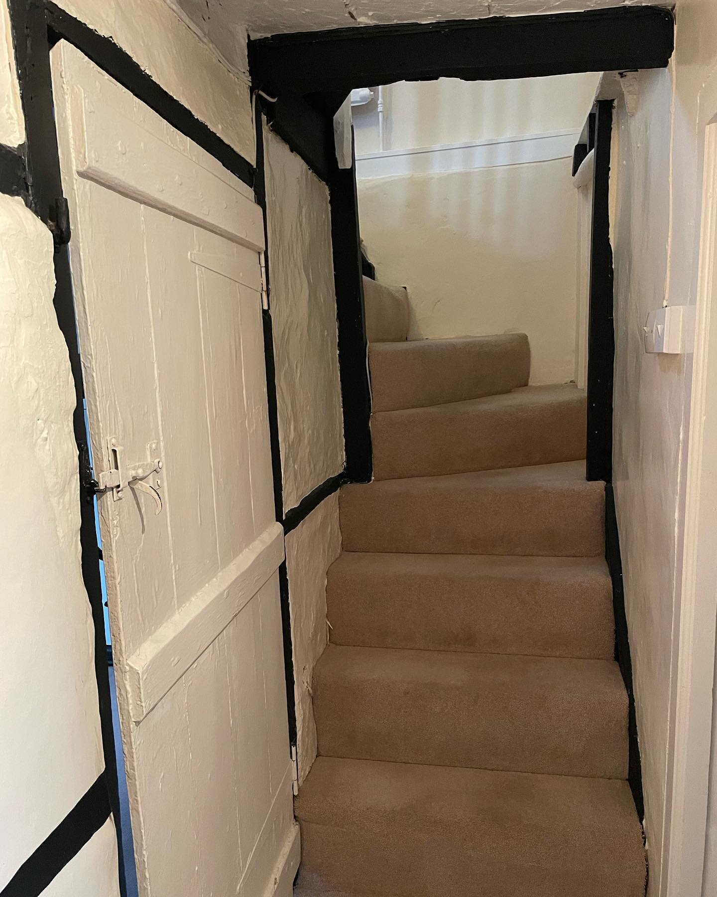 The downside of a 17th century cottage is the low beams, but we think ducking occasionally is well worth it, for these beautiful old features. We love the rays of sunlights falling down the stairs from the window above. #traditionalcottage #oldstairs