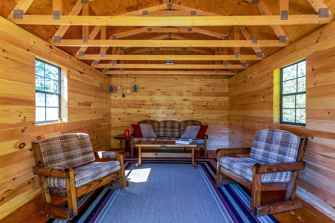 Classic Catskills log cabin with wood stove on a quiet historic road in