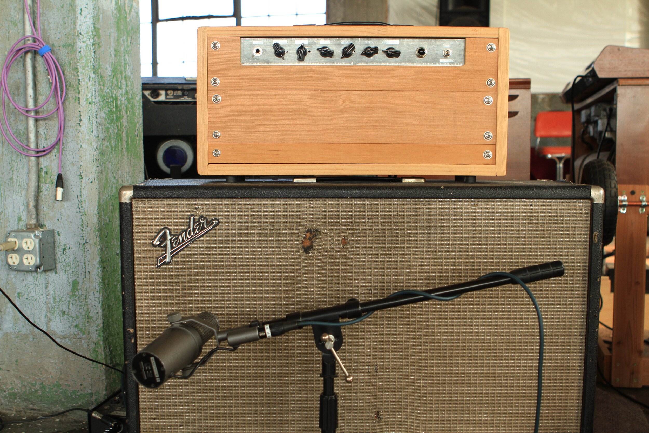 An original early Shure SM7 (Made in USA) on a 2x12 Bassman Speaker cab. These original SM7 microphones have square holes in the grill and are different in use than the later SM7B microphones. The cab is loaded with a pair of Jensen Blackbird Alnic