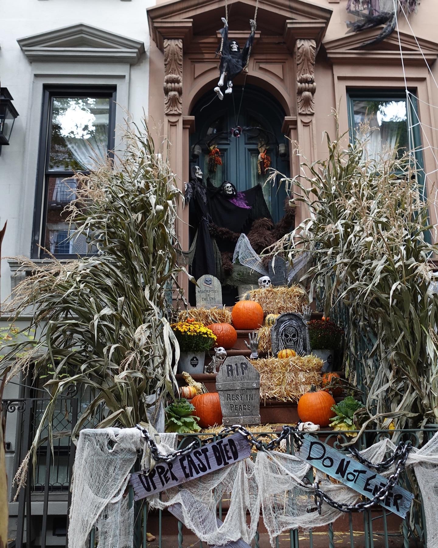  Halloween-decorated brownstone stoop with pumpkins in New York City 