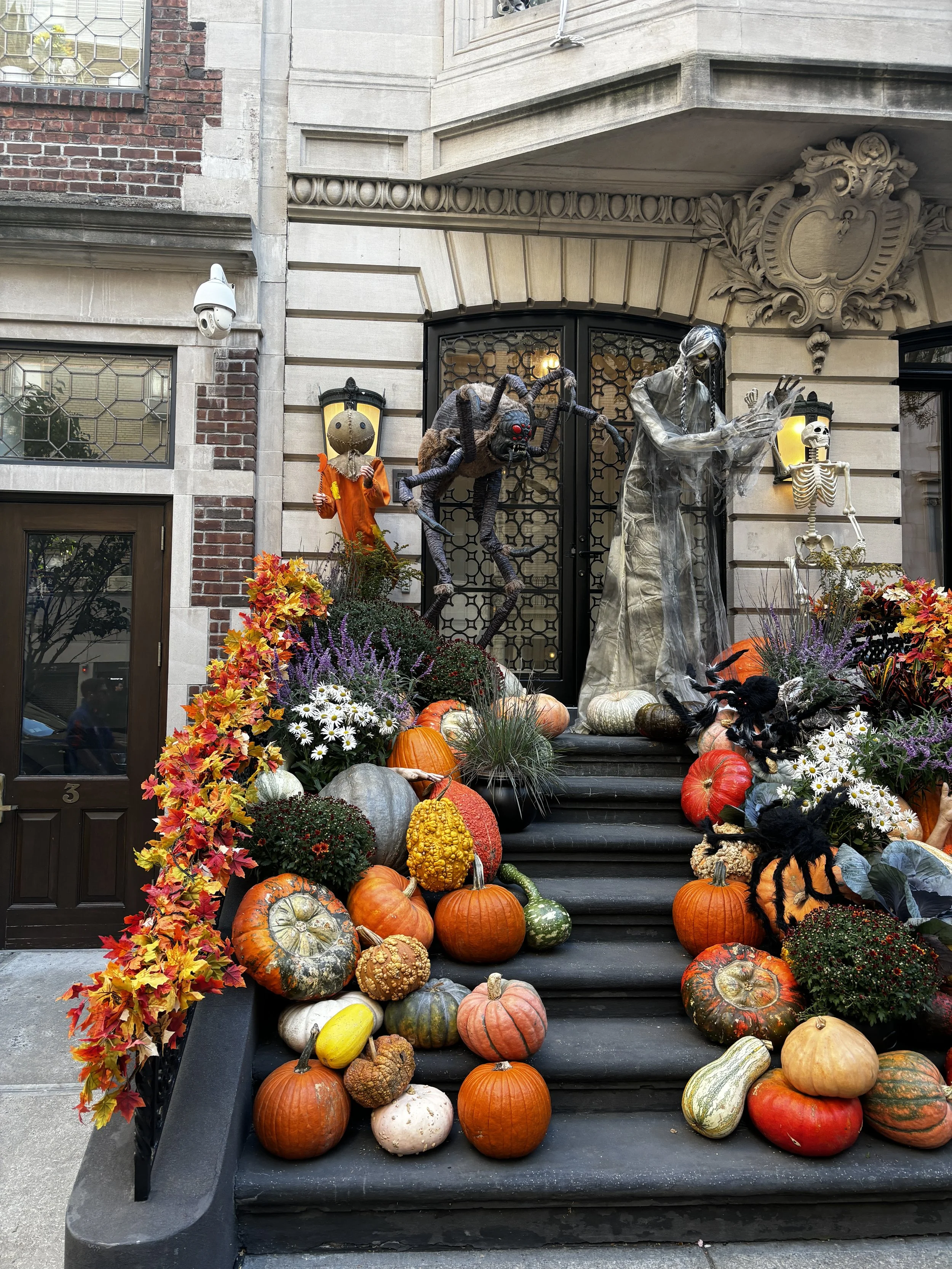  Front stoop of an Upper East Side brownstone covered in fall and Halloween decor 