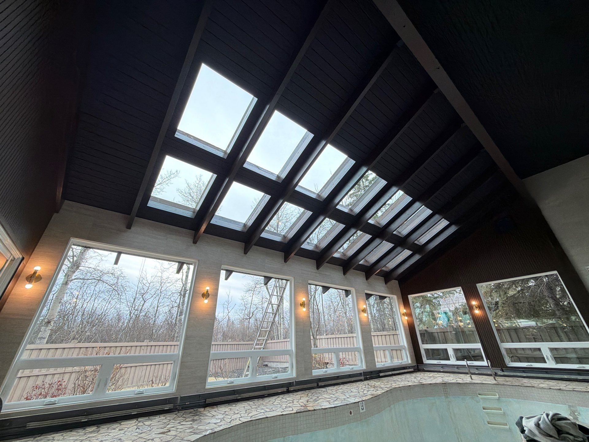Retrofitting old skylights into new Velux skylights: Edmonton indoor pool project
