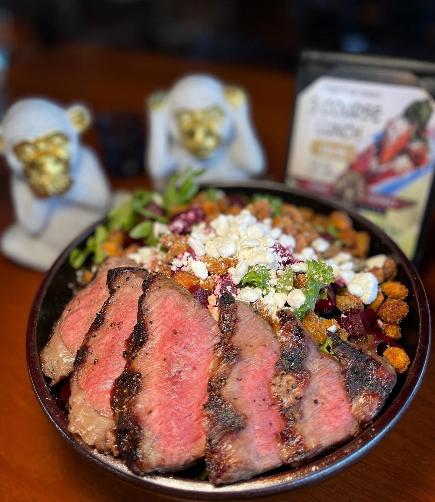 Pistachio Beet Salad- Mixed greens tossed with balsamic vinaigrette, topped with candied Cajun pistachios, roasted beets, crumbled goat cheese and a honey drizzle. Finished with a sliced 6 oz NY strip.