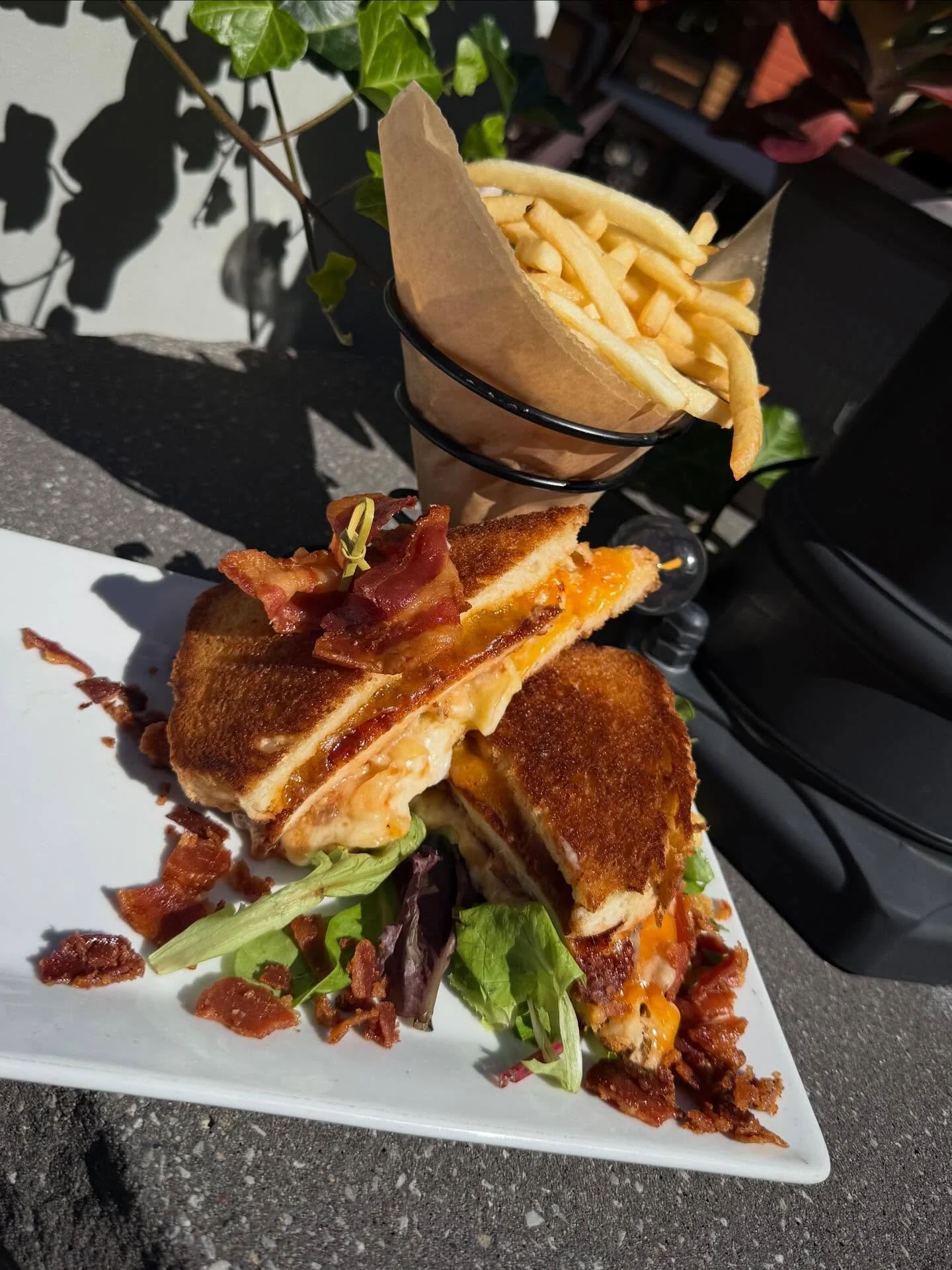 BBQ Chicken Mac Melt- Thick cut Texas toast layered with cheddar cheese, BBQ panko chicken, mac and cheese and crispy bacon, served with French cut fries