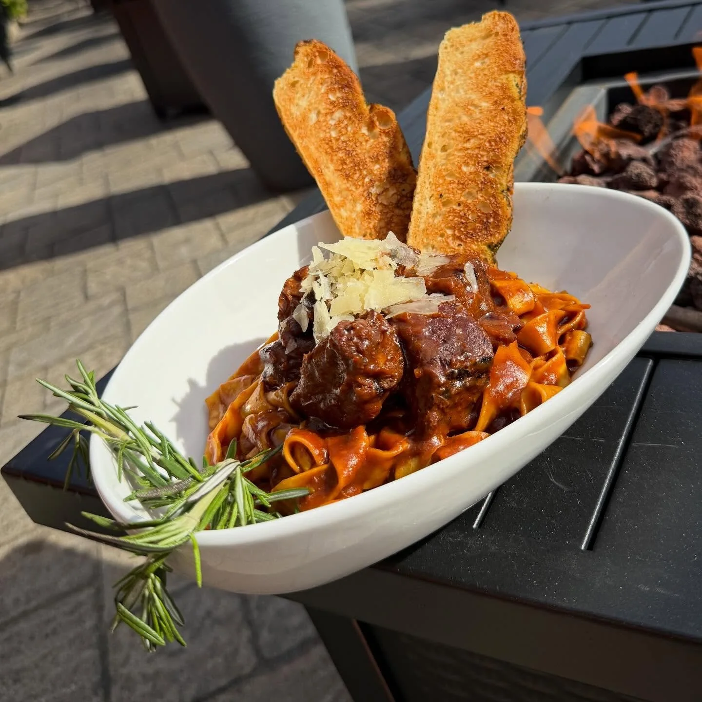 Truffle Short Rib Pappardelle - Succulent short ribs, slow braised in red wine, aromatic herbs, and a silky demi-glace until perfectly tender. Tossed with ribbons of fresh pappardelle and finished with focaccia, shaved parmesan and a touch of truffle