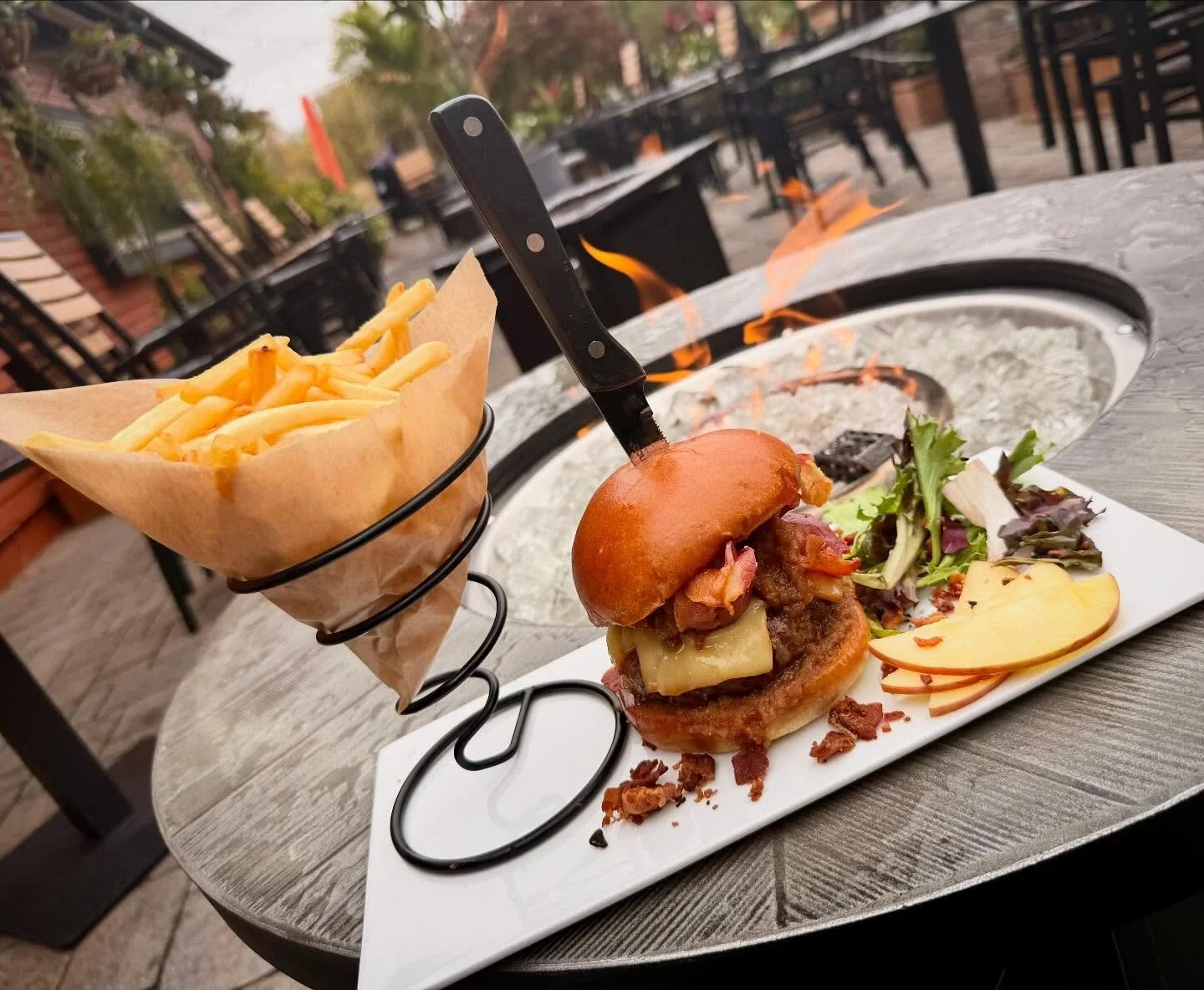 Vermonter Burger- Half pound hand pressed angus beef on a brioche bun topped with BBQ sauce, smoked gruyere cheese, maple whiskey apple jam, and crispy double smoked bacon. Served with French cut fries
