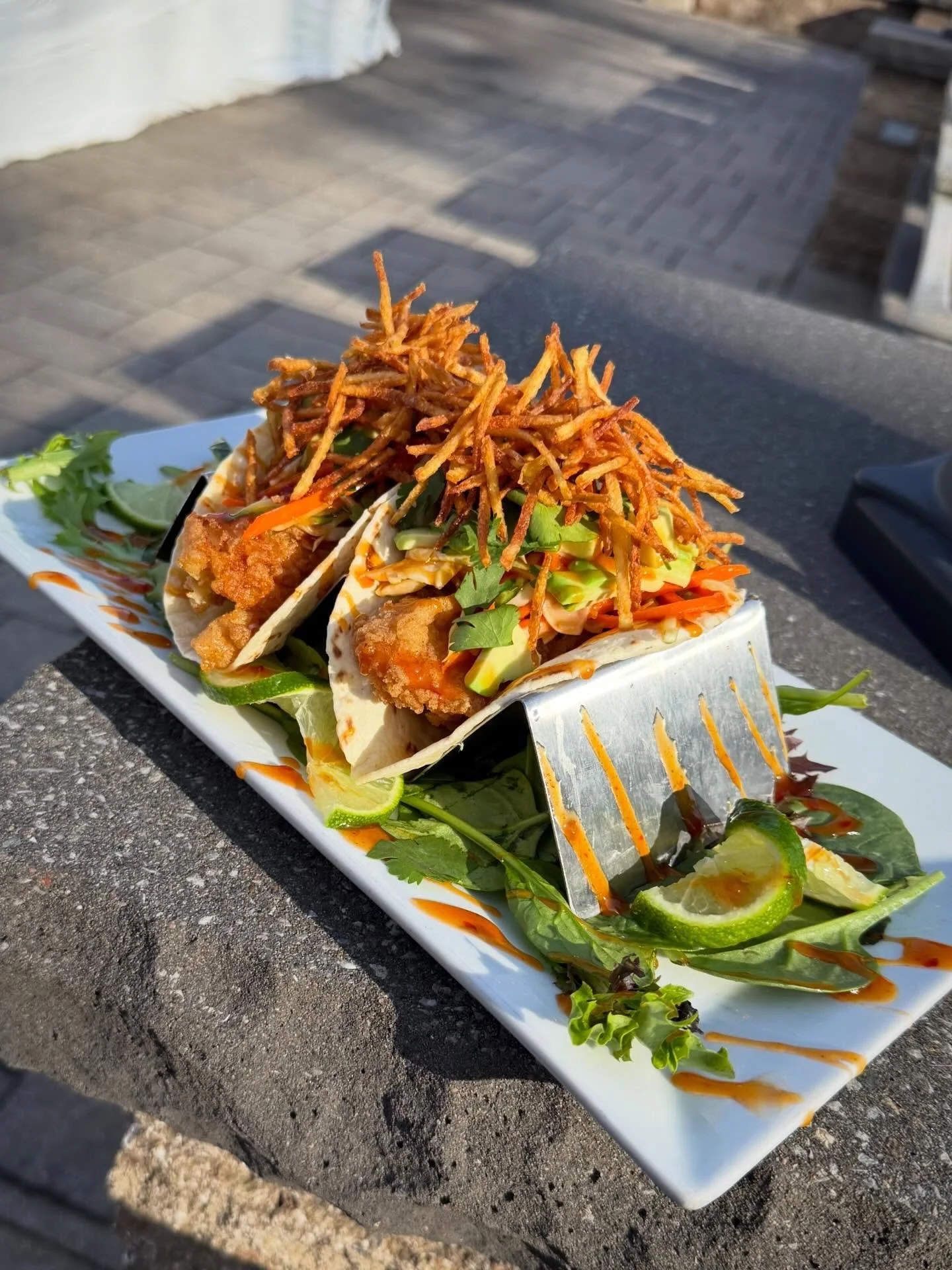Fish &amp; Chips Tacos:

Fresh cod loin is lightly dredged and fried until crispy. Served in two flour tortillas layered with a sweet and refreshing cucumber slaw. The tacos are finished with ripe avocado, cilantro, and crispy potato straws
