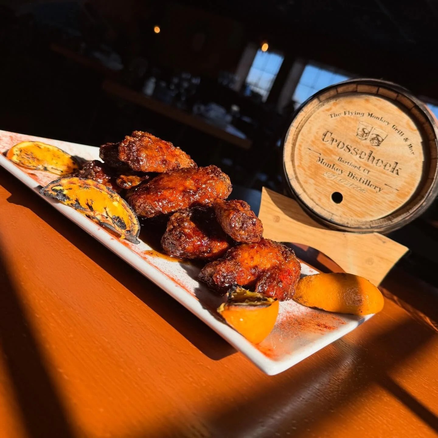 Crosscheck Old Fashioned Wings- Bourbon crosscheck glaze with brown sugar, orange peel, Angostura bitters, and a touch of cherry syrup. Finished with smoked paprika and hickory smoke and charred orange