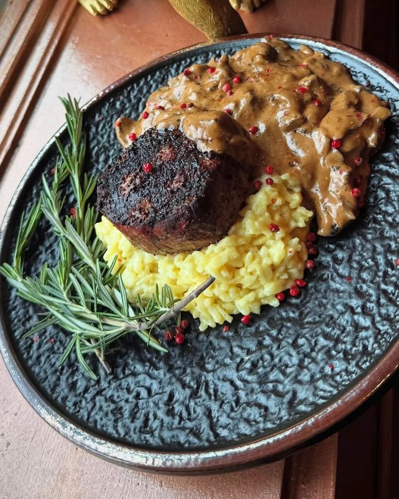 Captains Cognac Filet- 8 oz center cut filet grilled with our house steak rub, served over creamy parmesan risotto and finished with a creamy Henessey mushroom sauce with fresh thyme