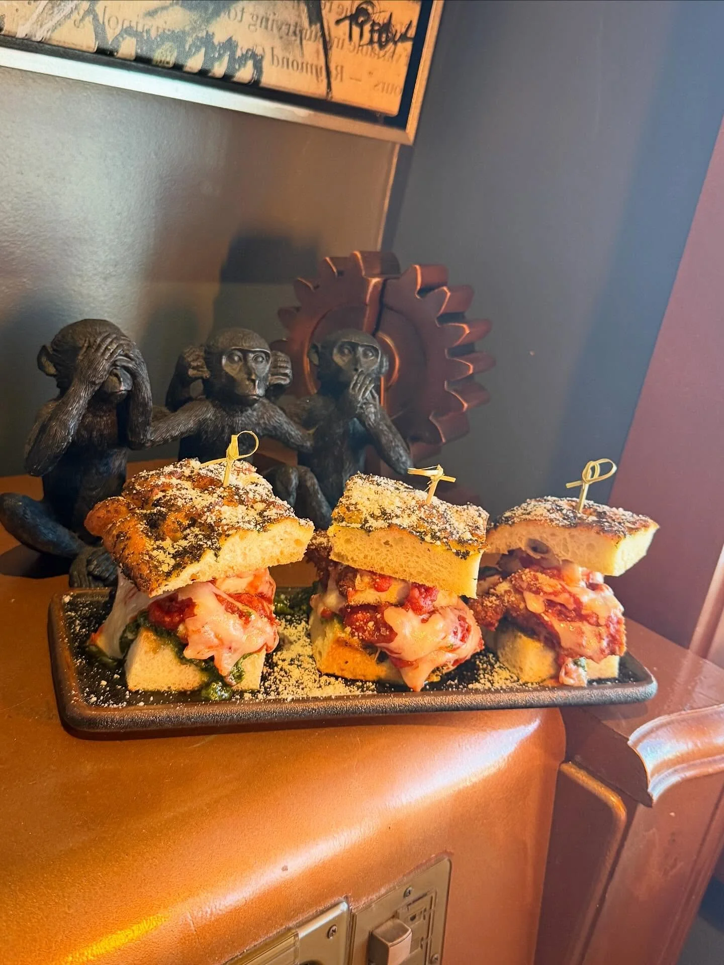 Flight Deck Focaccia Sliders- Parmesan panko crusted chicken topped with fresh mozzarella, slow-simmered marinara and pistachio pesto on herbed olive-oil focaccia