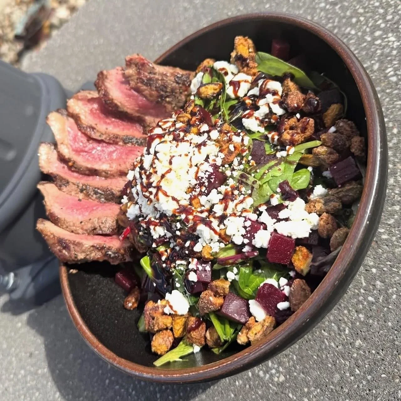 Pistachio Beet Salad- Mixed greens tossed with honey balsamic vinaigrette, topped with candied Cajun pistachios, roasted beets, crumbled zoat cheese and a balsamic drizzle. Finished with a sliced 6 oz center cut NY strip